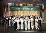 Die Ehrungsgruppe 4 wurde auf der Bühne durch den Ersten Bürgermeister Andreas Hein und Detflef Maaß, Amtsleiter Amt für Sport, Freizeit und außerschulisches Lernen, geehrt.